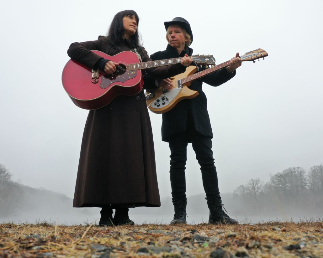 Photo of THe Kennedys holding guitars