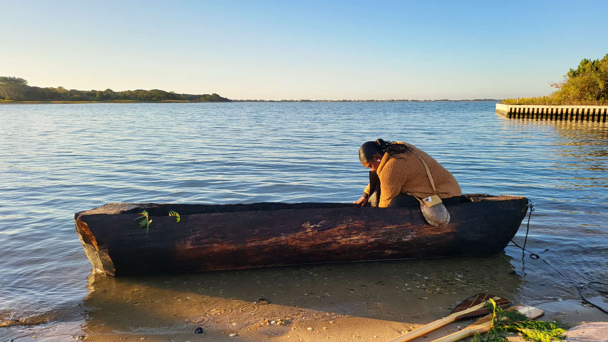 Chenae Bullock (Shinnecock Tribal Citizen) first launching her newly made Mishoon in the Shinnecock Bay