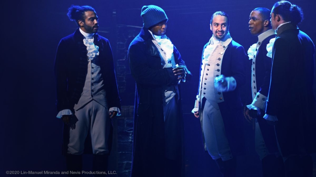 Photo of actors on stage during a production of Hamilton