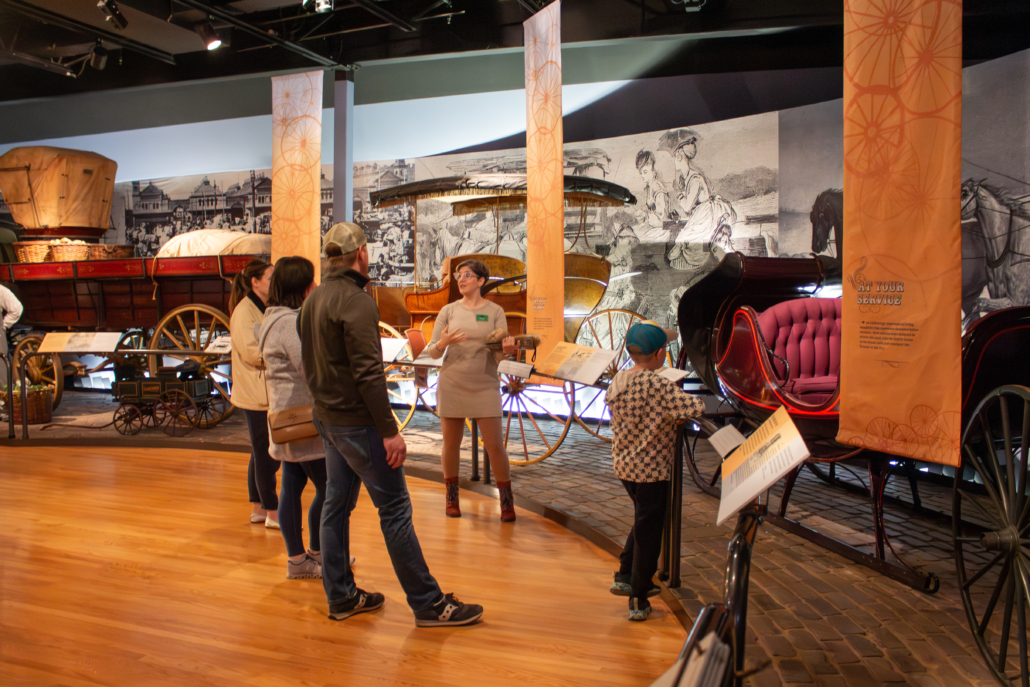 Docent leading a tour in the Carriage Museum.