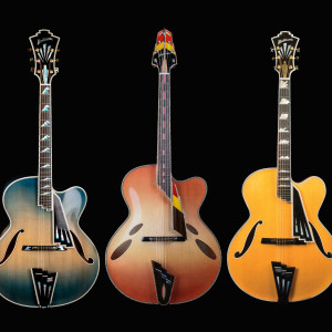 Three isolated ornate guitars by John Montelone